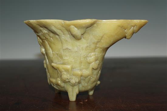 A Chinese pale green soapstone libation cup, 19th century, width 18.5cm, height 10cm, faults